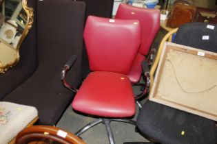 A pair of metal framed swivel office chairs