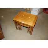 A nest of three pine occasional tables