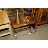 A reproduction mahogany drop leaf side table