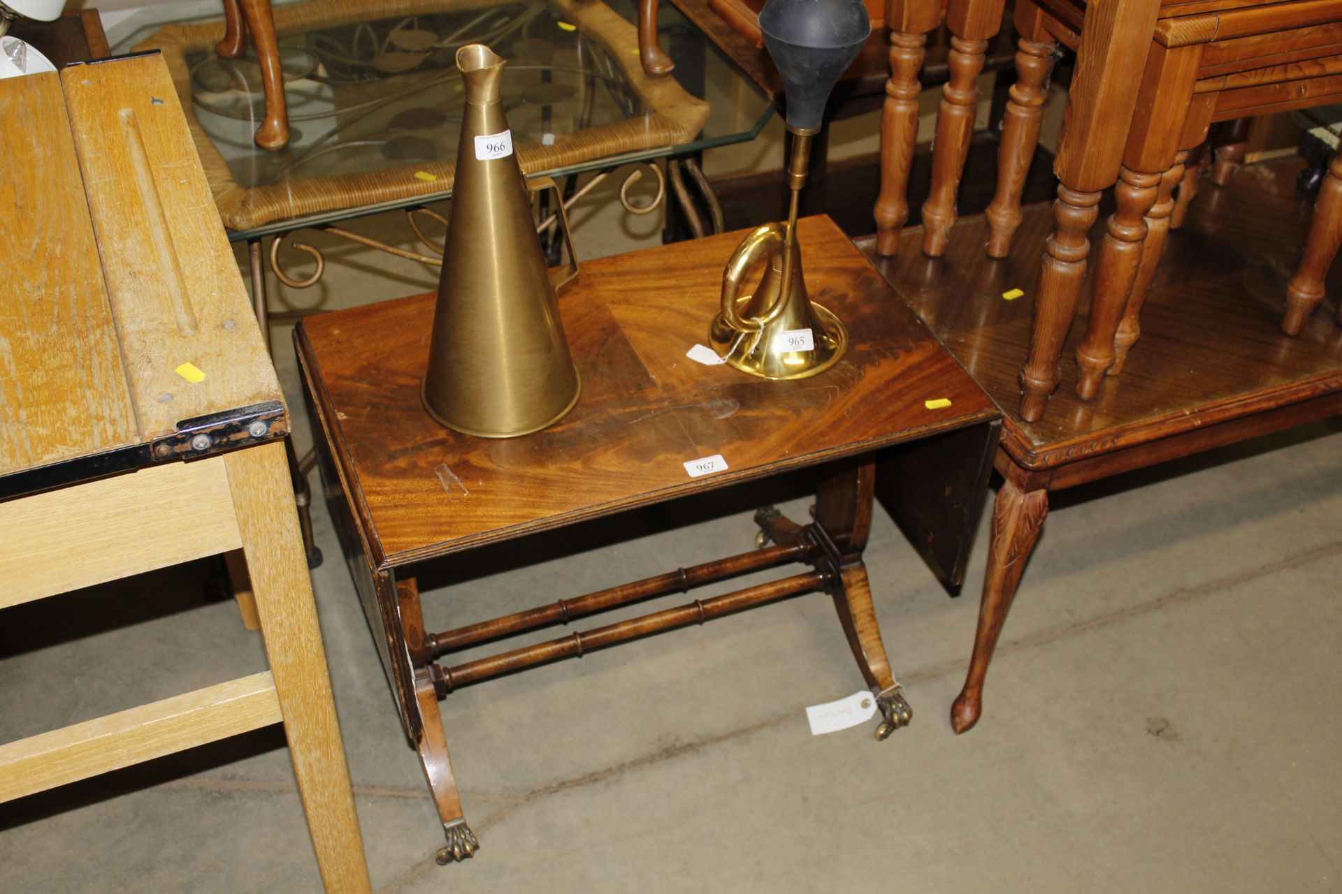 A reproduction mahogany drop leaf side table