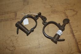 A pair of handcuffs (156)