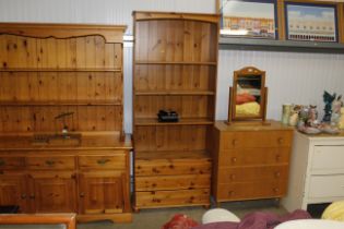 A pine bookcase with adjustable shelves, fitted th