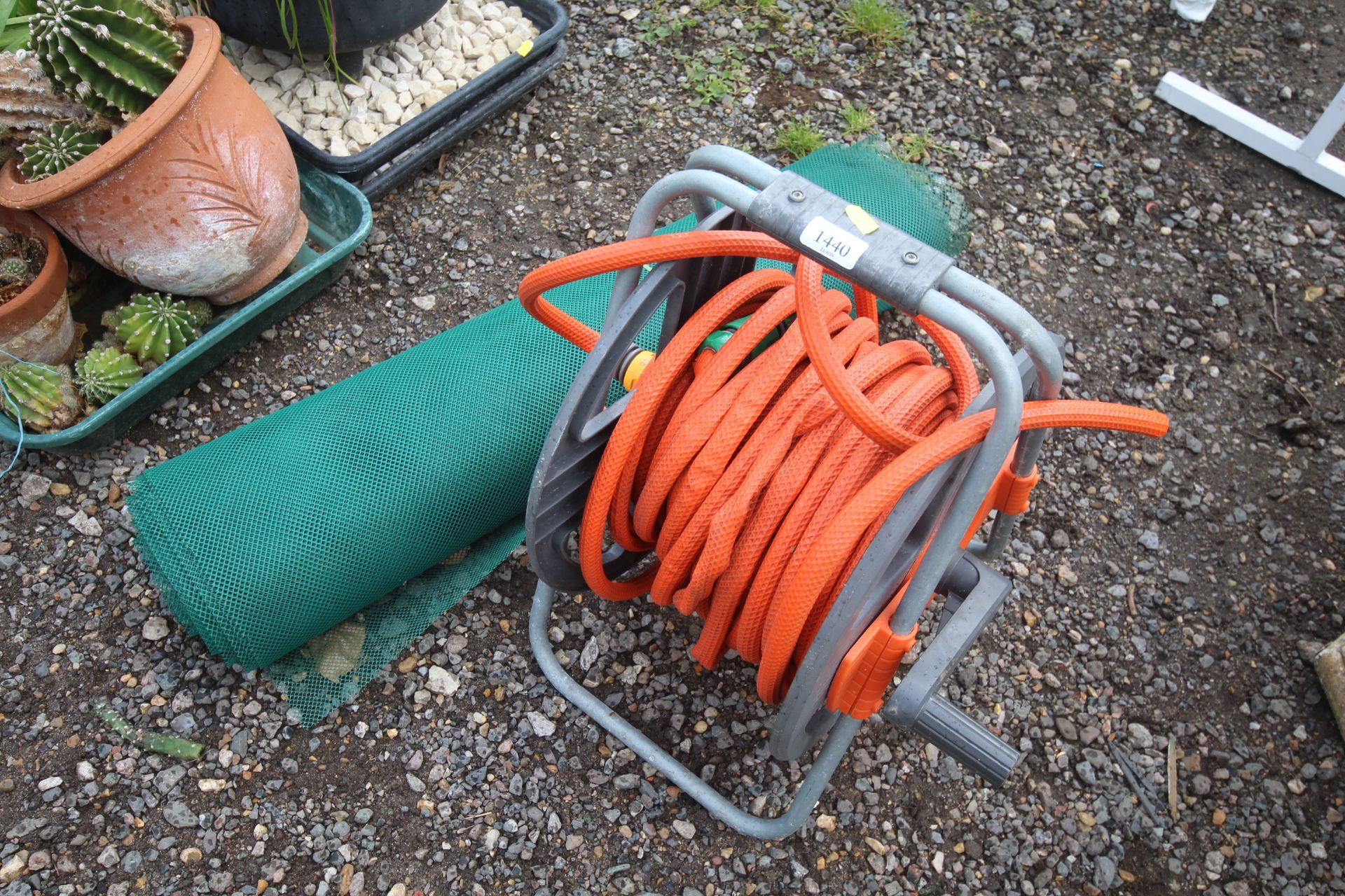 A length of garden hose on a reel together with a