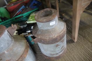 A galvanised milk churn with wrought metal swing h