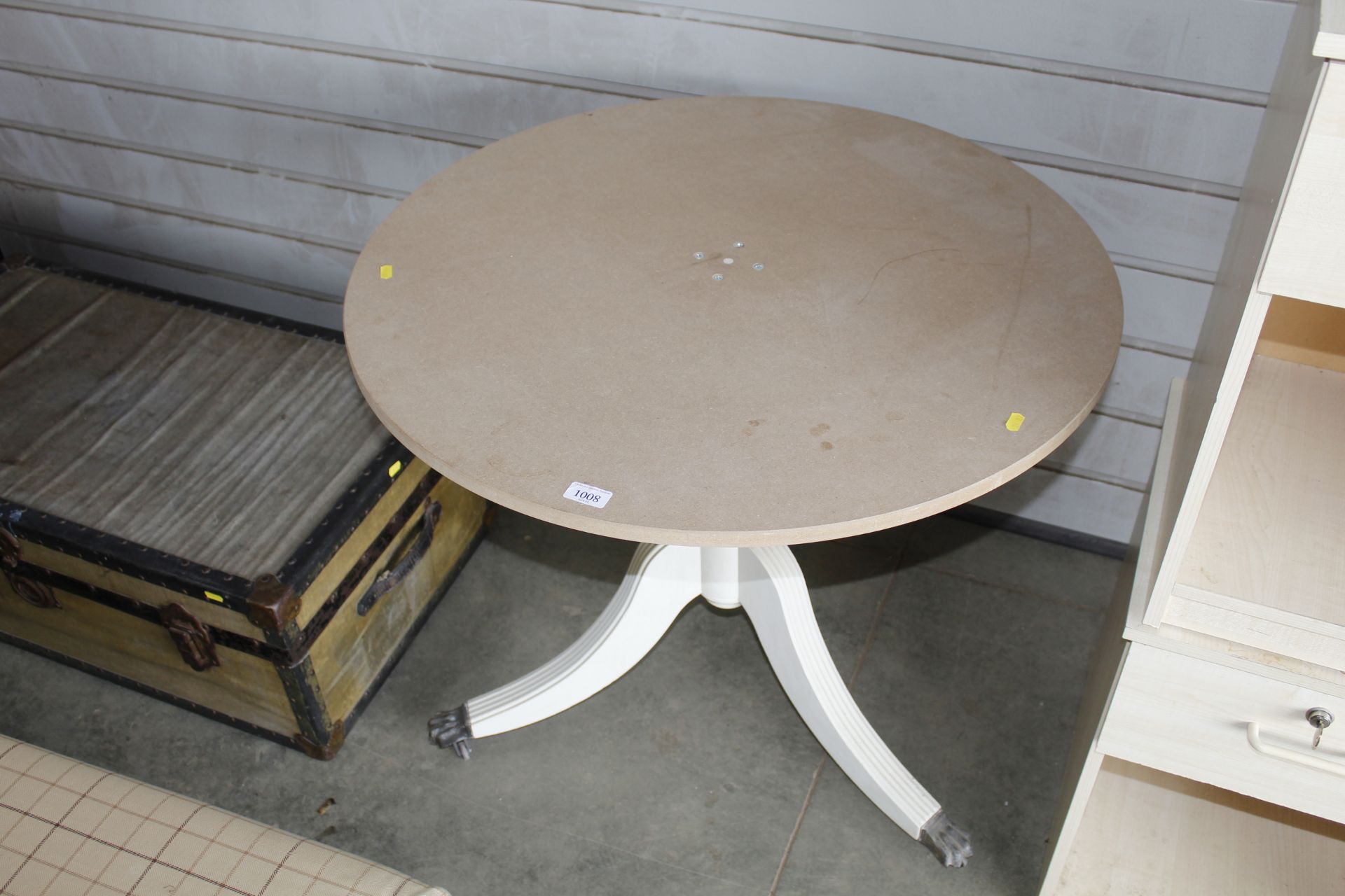 A circular top table raised on tripod base