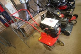 An MTD T245 petrol front tine tiller with instruct