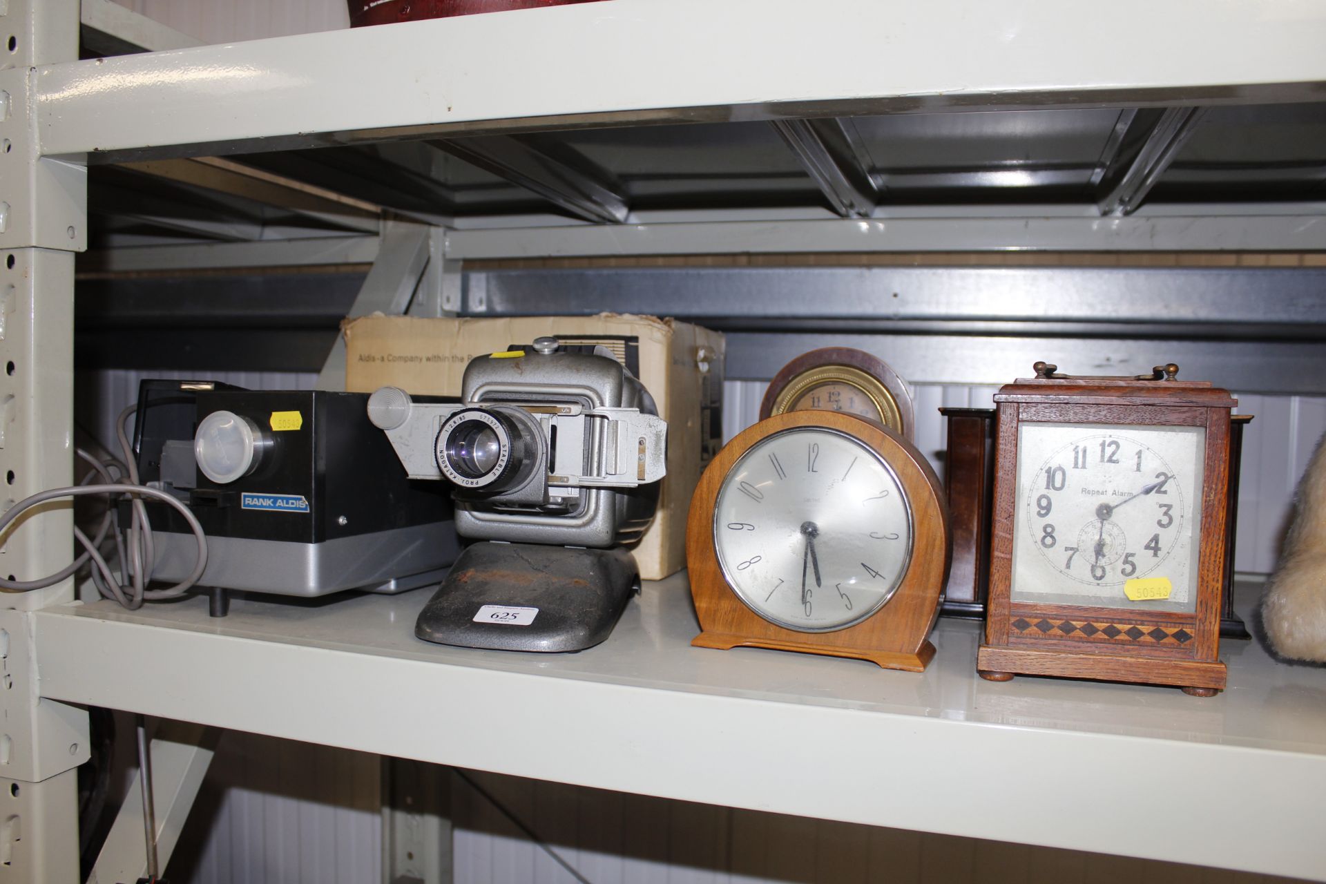 Four various mantel clocks; a Norris projector and