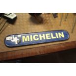 An oval cast iron painted sign for Michelin measuring approx. 19.5" x 3.5" (188)