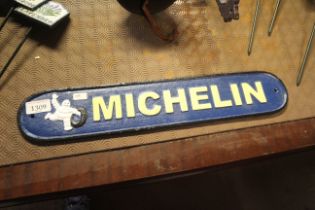 An oval cast iron painted sign for Michelin measuring approx. 19.5" x 3.5" (188)