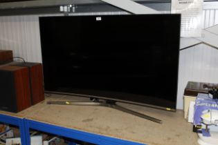 A Samsung curved television with remote control