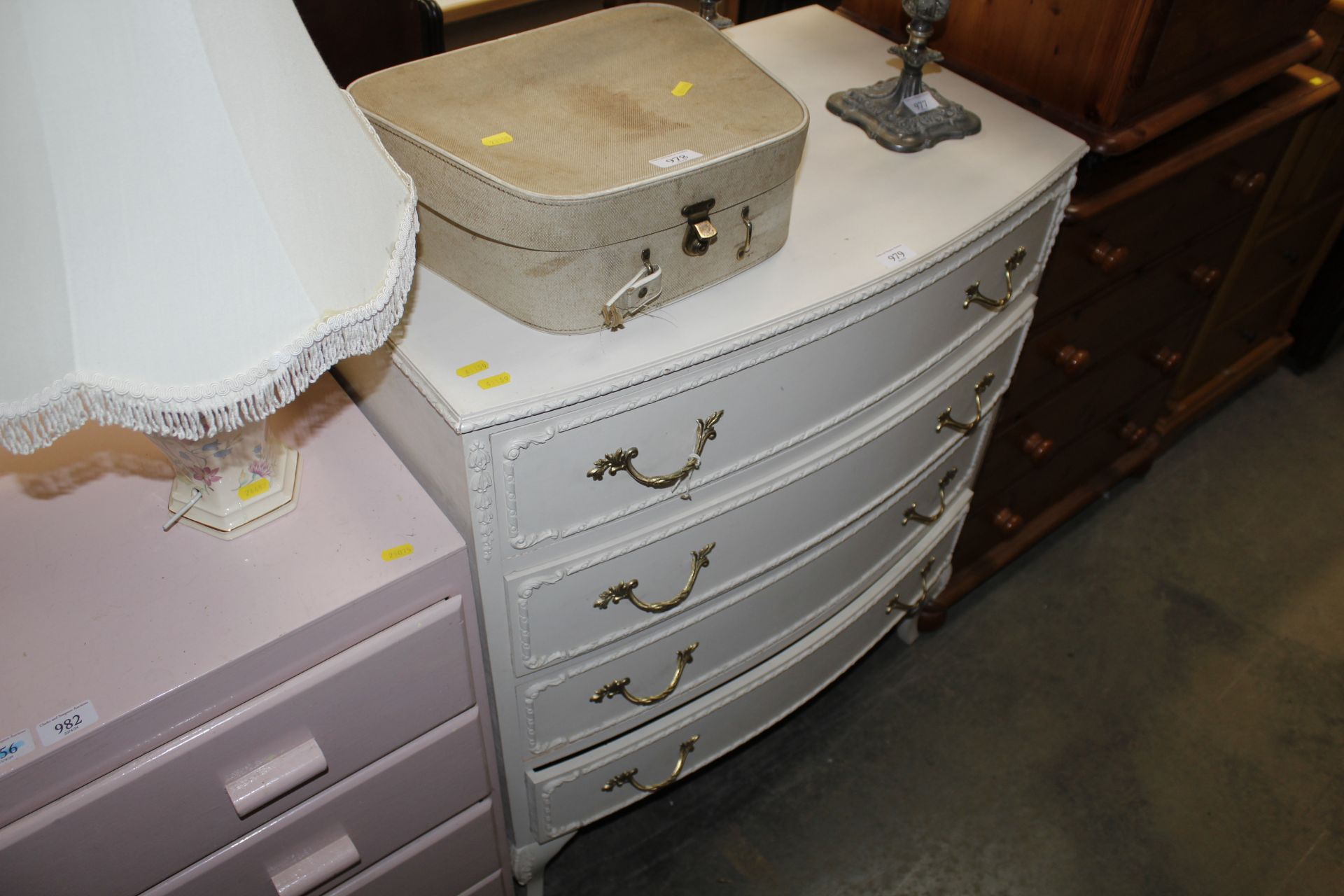 A cream bow front chest fitted four drawers