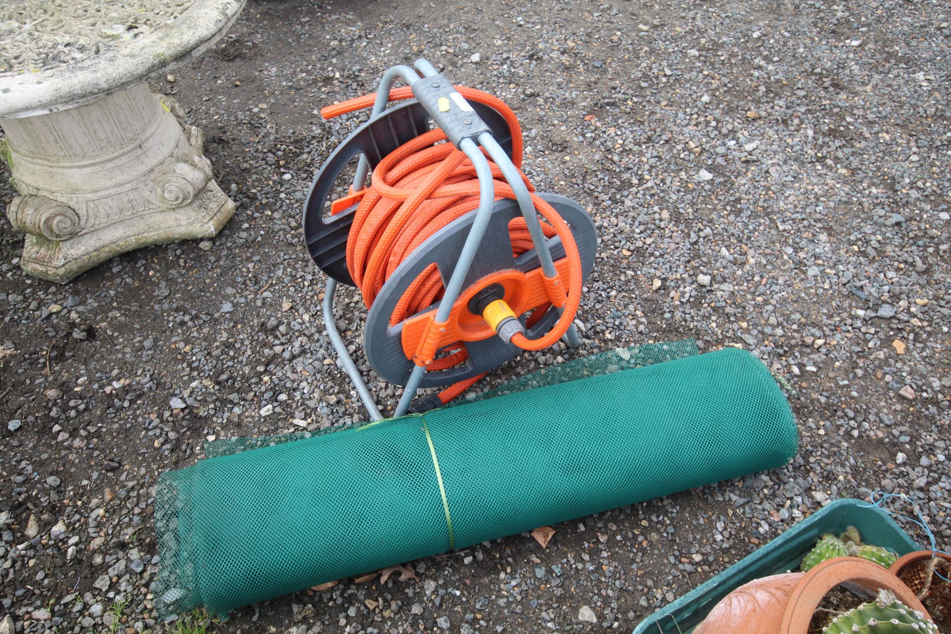 A length of garden hose on a reel together with a - Image 2 of 2