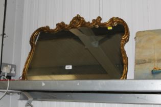 An ornate gilt framed wall mirror