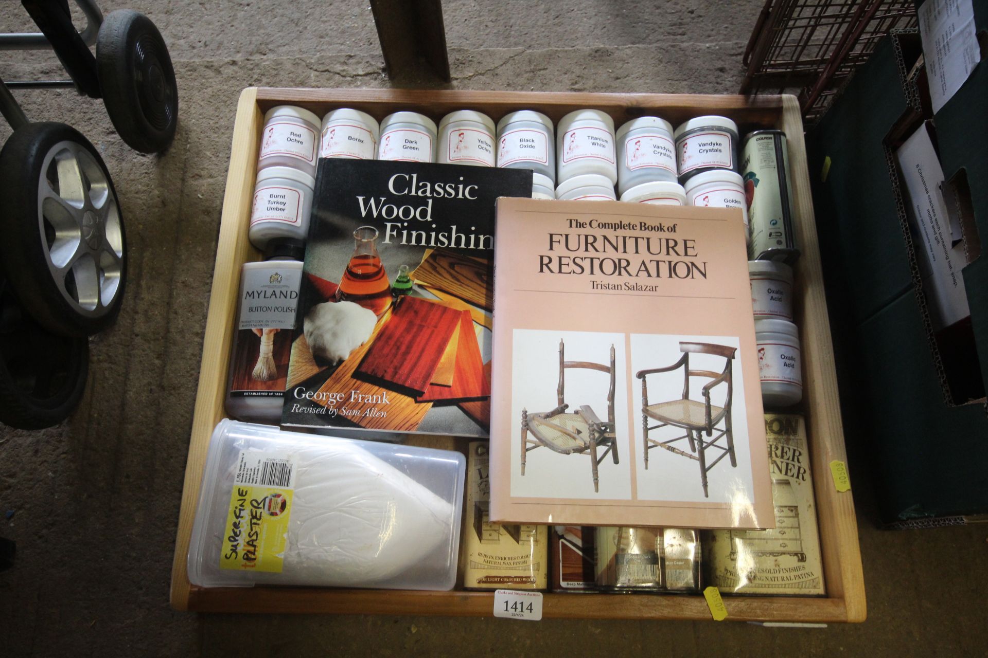 A wooden tray containing various liquid waxes, pol