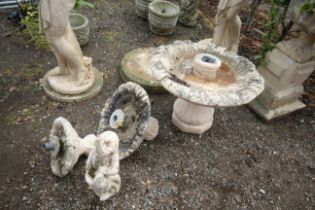 An ornate four part concrete water feature with fi