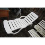 A plastic reclining garden lounger