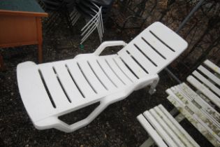 A plastic reclining garden lounger