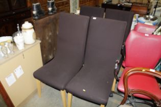 A set of four modern dining chairs