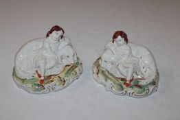 A pair of Staffordshire ornaments in the form of d