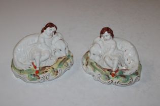 A pair of Staffordshire ornaments in the form of d