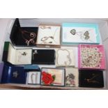 A box containing various boxed costume jewellery