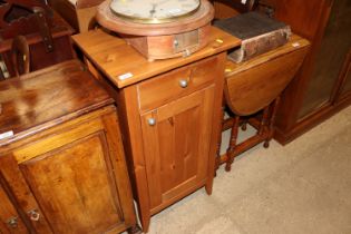 A pine cupboard fitted with a single drawer