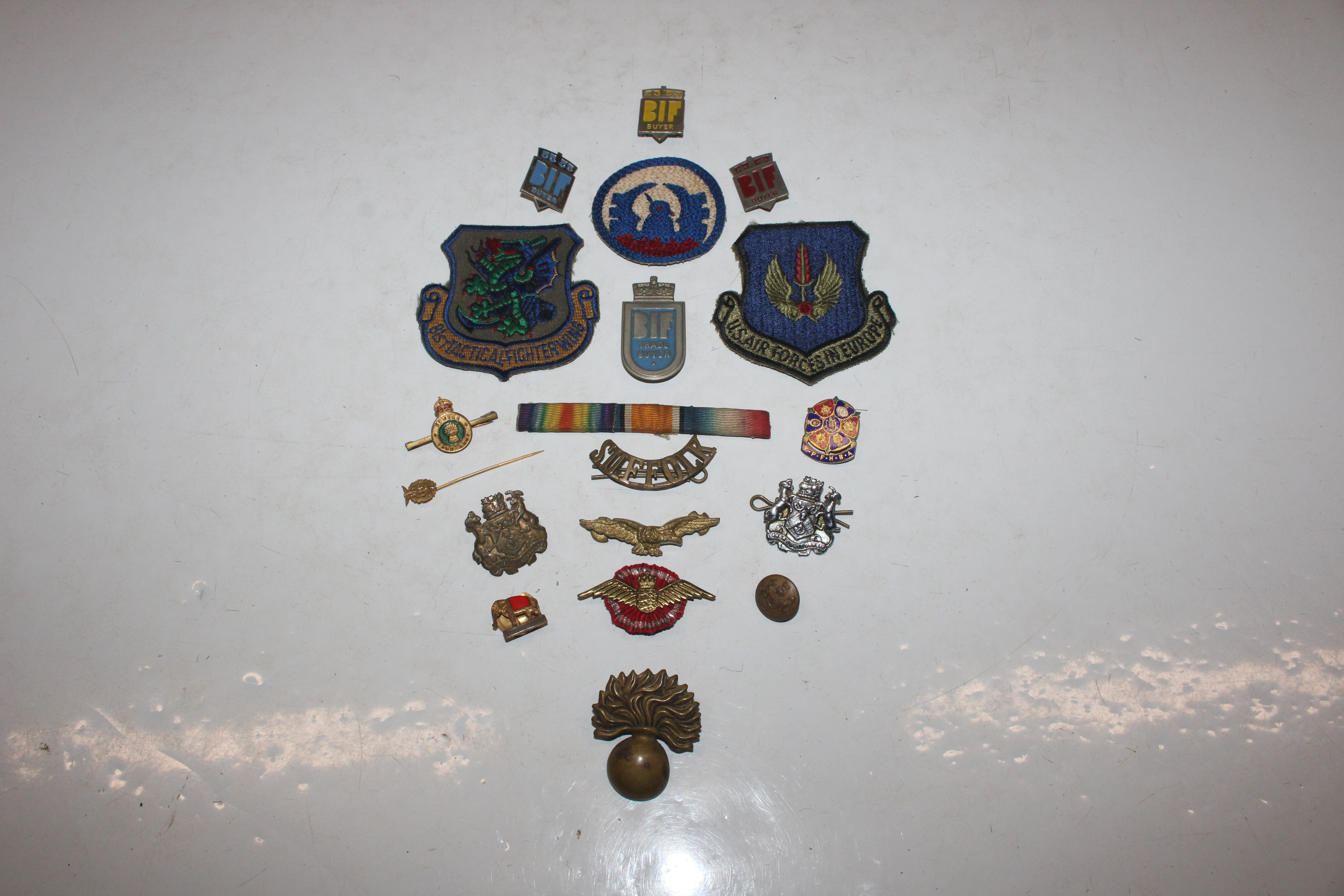 A box of military related and other cloth badges