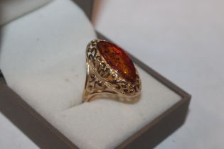 A Sterling silver gilt and amber set ring, ring si