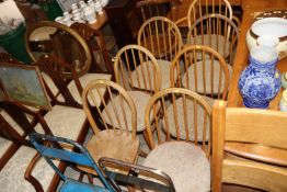 Seven blonde Ercol stick back kitchen chairs, six