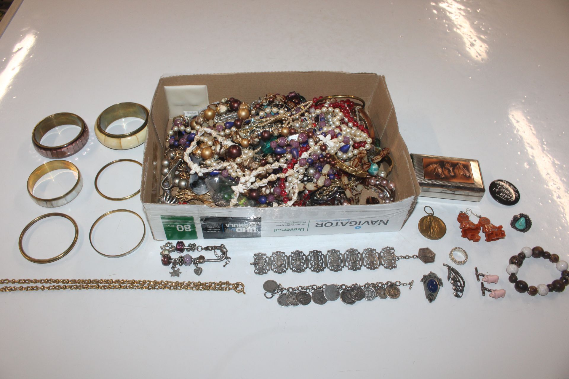 A box containing various costume jewellery includi