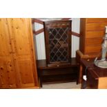 An oak and leaded glazed hanging corner cupboard;