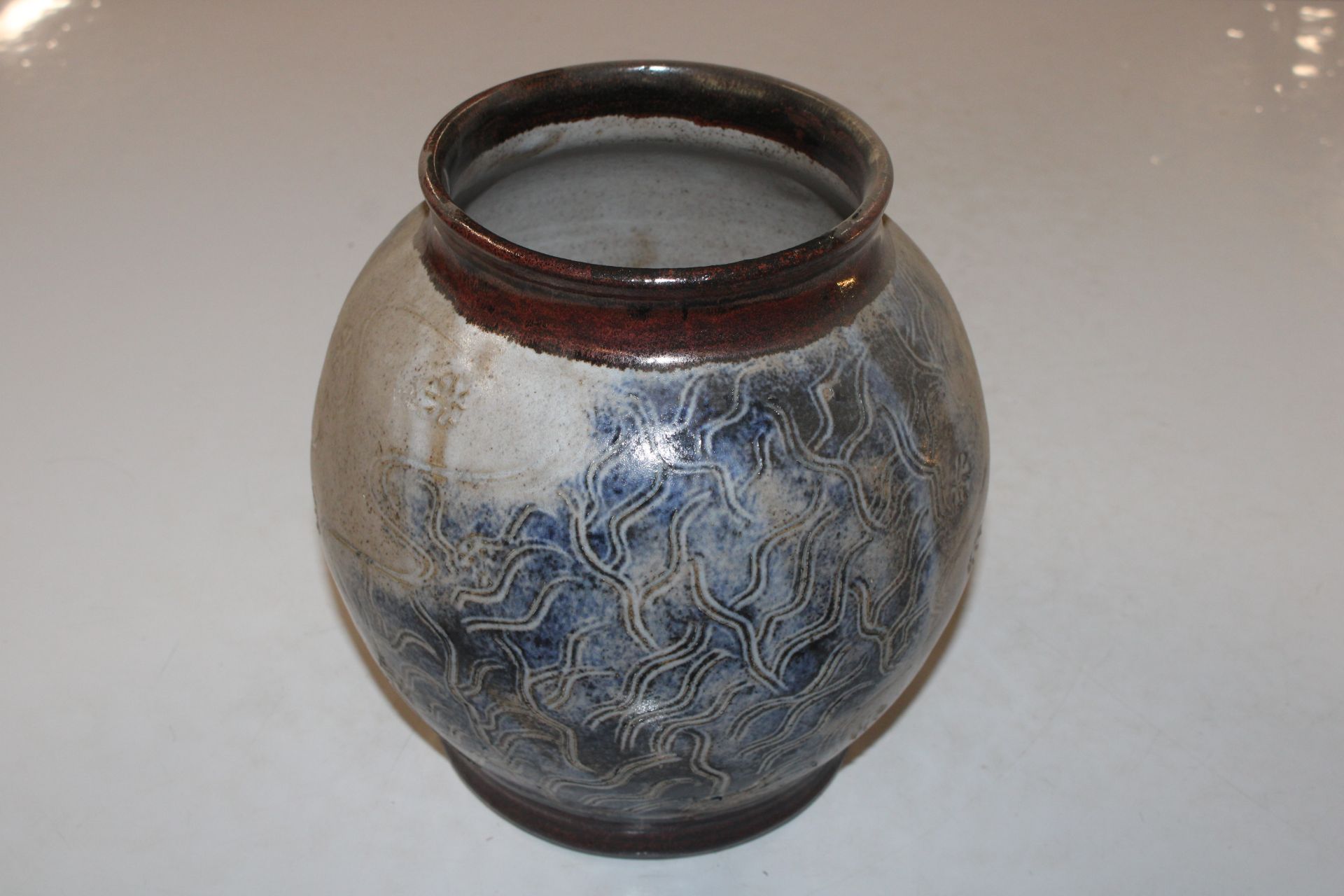 A Studio pottery baluster vase having incised flor