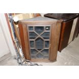 An antique mahogany hanging corner cupboard