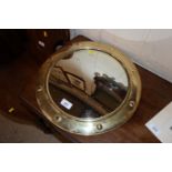 A circular brass framed convex wall mirror