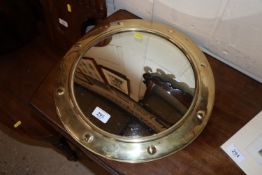 A circular brass framed convex wall mirror