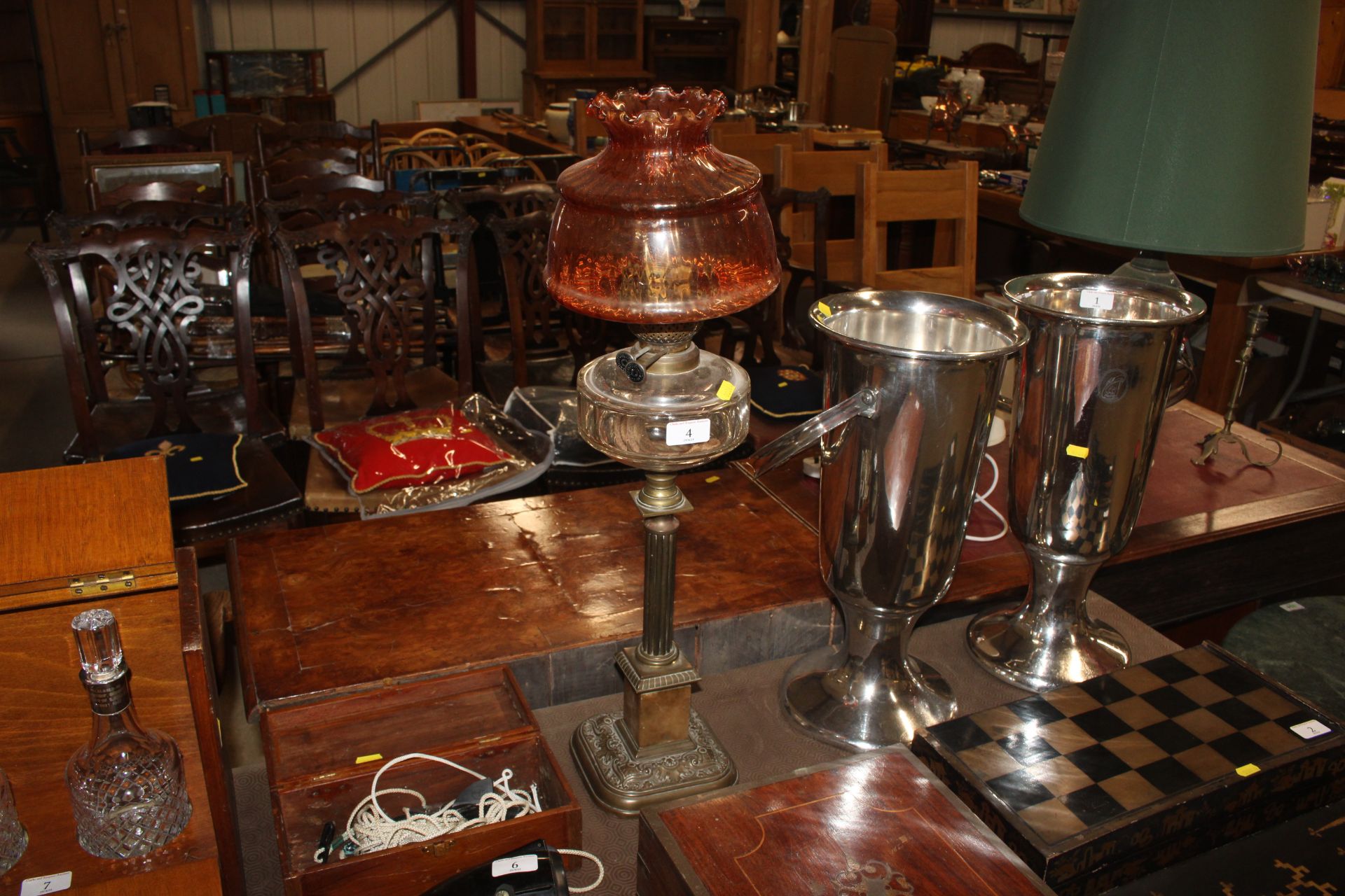 A Victorian table oil lamp supported on a brass Co