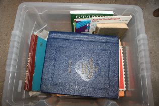 A box containing two stamp albums, loose stamps an