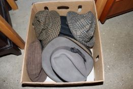 A box of vintage men's hats