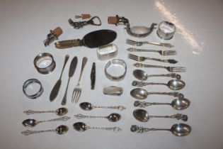 Four silver napkin rings; two silver knives; a sil