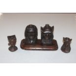 A pair of wooden stands in the form of carved head