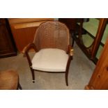 A mahogany cane back elbow chair