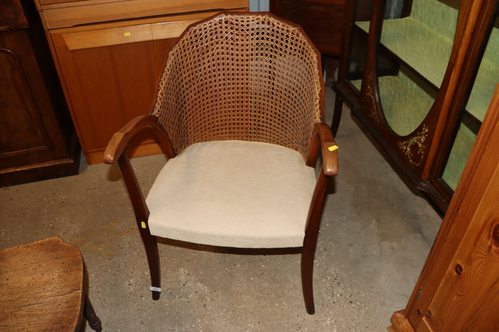 A mahogany cane back elbow chair