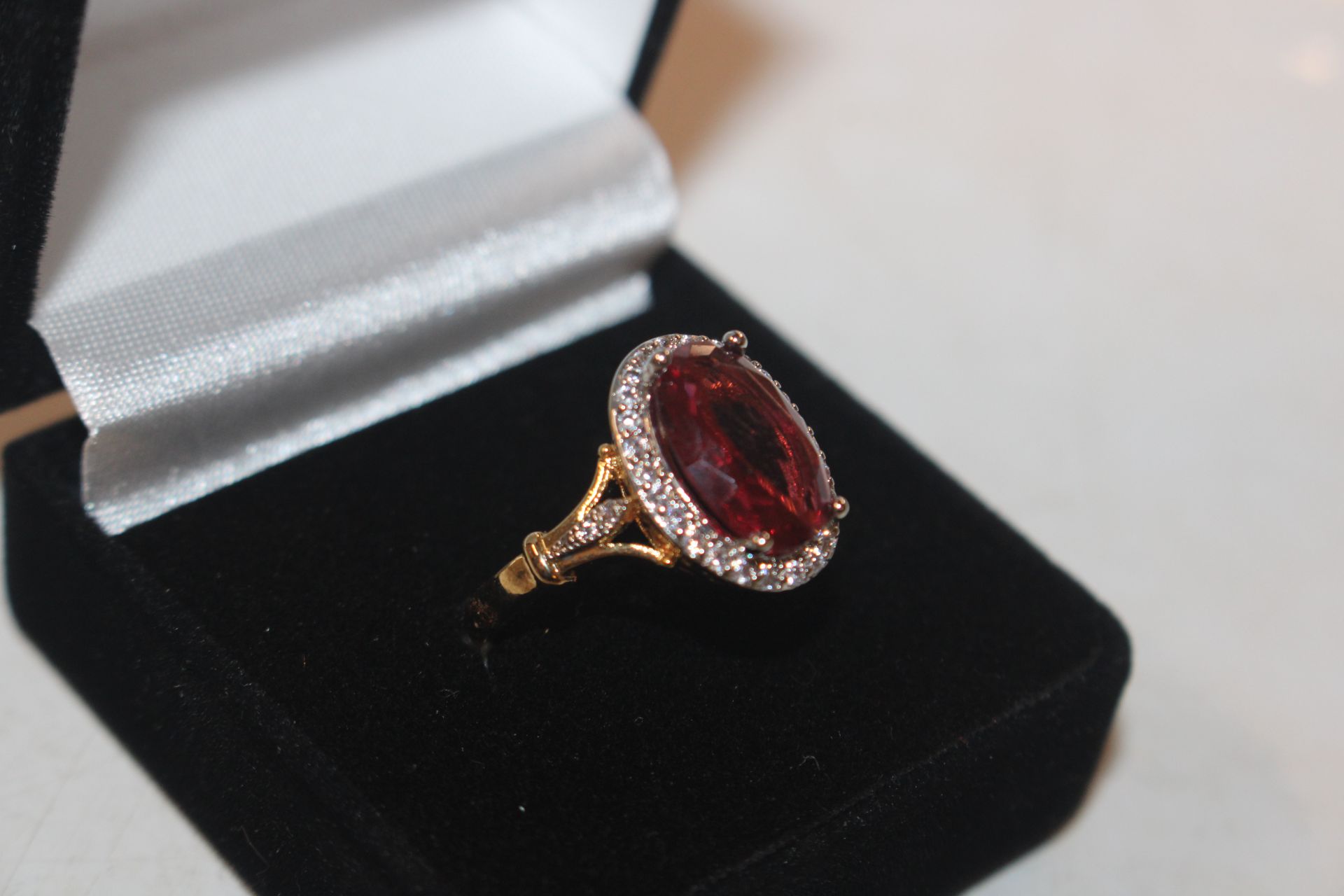 A 925 silver gilt ring set with ruby coloured ston