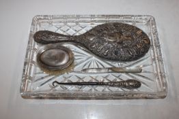A glass tray containing silver backed dressing tab