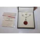 A Sterling silver and amber set pendant hung to ch