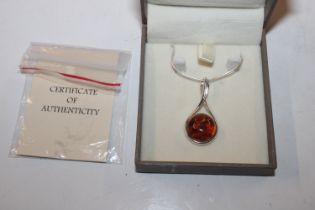 A Sterling silver and amber set pendant hung to ch