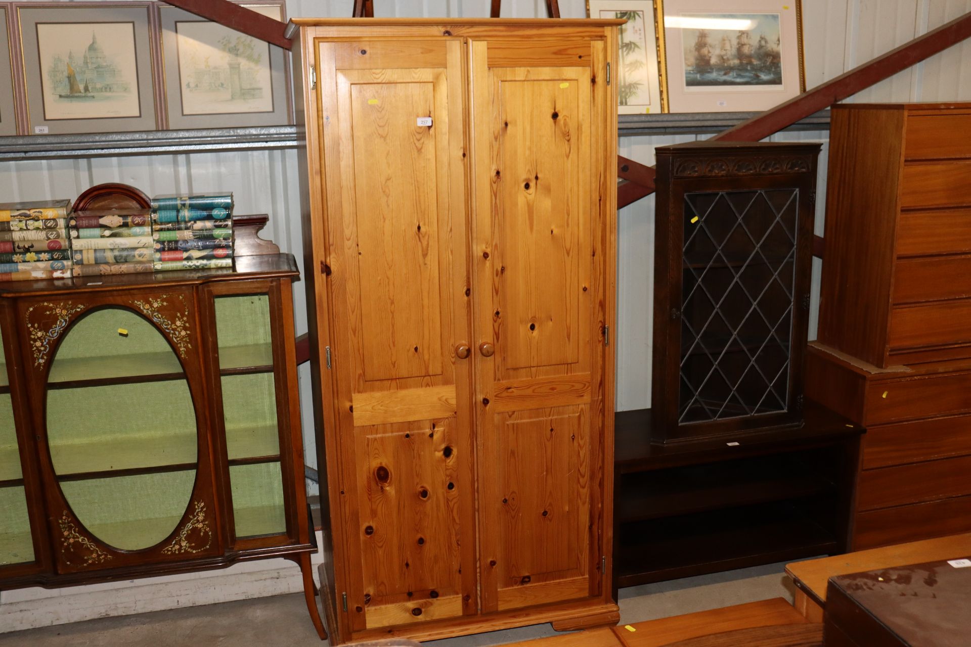 A modern stripped pine hanging wardrobe