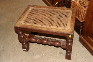 A walnut framed stool with cane seat