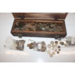 A wooden box and contents of various coinage