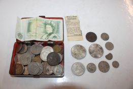 A box containing various coinage and a £1 note